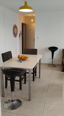 a table and chairs with a bowl of fruit on it at Departamento 1 dormitorio in Cordoba