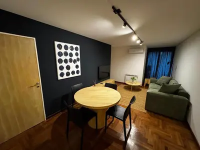 a living room with a table and a couch at Modern apartment - Nueva Córdoba in Cordoba