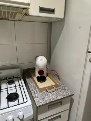 a kitchen with a stove and a white appliance on a counter at Modern apartment - Nueva Córdoba in Cordoba