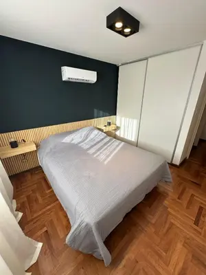 a bedroom with a bed and a black wall at Modern apartment - Nueva Córdoba in Cordoba
