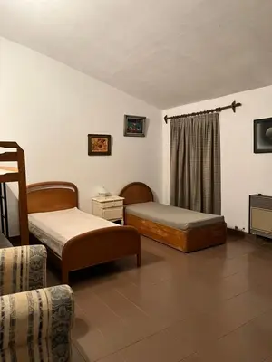 a hotel room with two beds and a couch at La Gregoria in Carpintería