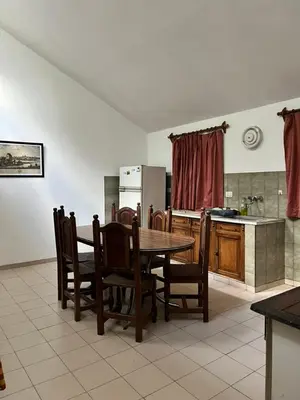 a kitchen with a wooden table and chairs and a kitchen with a kitchen at La Gregoria in Carpintería