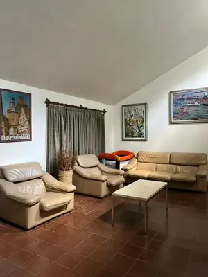 a living room with two couches and a table at La Gregoria in Carpintería