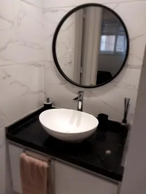 a bathroom with a white sink and a mirror at Chacabuco 275 By Suviex in Cordoba