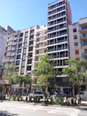 a tall building with trees in front of a street at Chacabuco 275 By Suviex in Cordoba