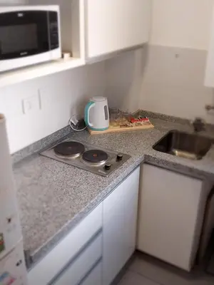 a kitchen with a counter top with a microwave at Chacabuco 275 By Suviex in Cordoba