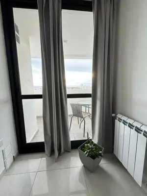 a room with a large window with a view of a patio at Avellaneda Homestay in Cordoba
