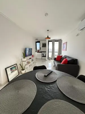 a living room with a table and a couch at Avellaneda Homestay in Cordoba