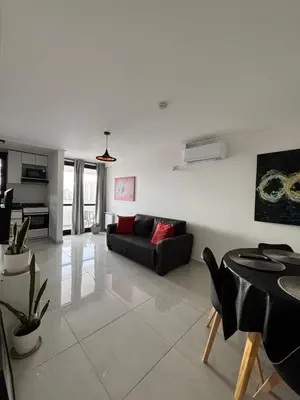 a living room with a couch and a table at Avellaneda Homestay in Cordoba