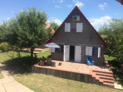 a small house with a blue chair and an umbrella at Complejo BIALET MASSE in Bialet Massé