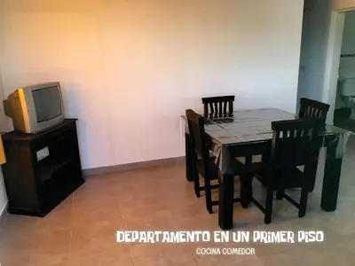 a dining room with a table and a tv at Complejo BIALET MASSE in Bialet Massé