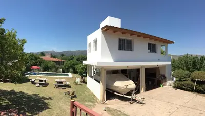 a white house with a pool in the yard at Complejo BIALET MASSE in Bialet Massé