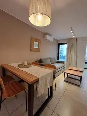 a living room with a table and a couch at Chacabuco 400 B Nueva Cordoba in Cordoba