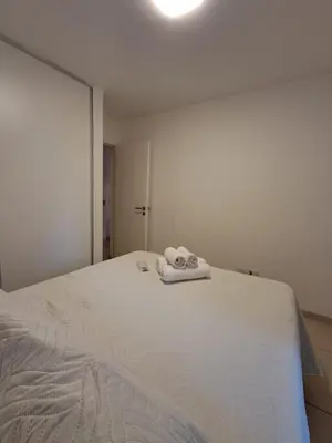 a white bed with two towels on top of it at Chacabuco 400 B Nueva Cordoba in Cordoba