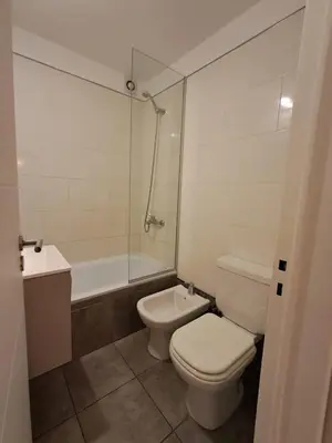 a bathroom with a toilet and a sink and a tub at Chacabuco 400 B Nueva Cordoba in Cordoba