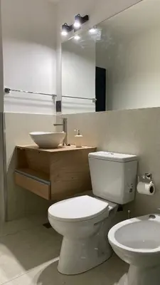 a bathroom with a white toilet and a sink at Departamento Plaza Colón in Cordoba