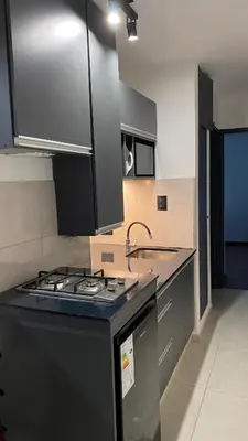 a kitchen with a stove top and a sink at Departamento Plaza Colón in Cordoba