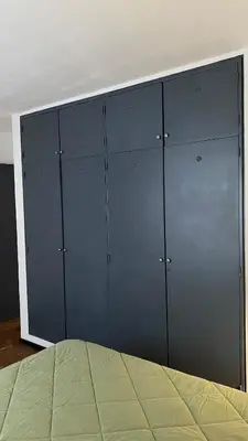 a large closet with blue doors in a room at Departamento Plaza Colón in Cordoba