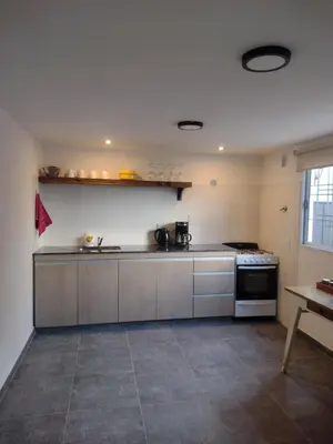 a kitchen with stainless steel cabinets and a stove at Tierra Madre in Santa Rosa de Calamuchita