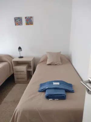 a blue shirt sitting on top of a bed at Tierra Madre in Santa Rosa de Calamuchita