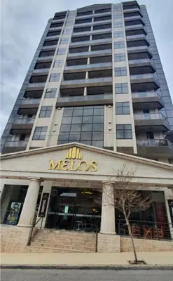 a large building with a mhettos sign on it at Edificio Melos Villa Carlos Paz in Villa Carlos Paz