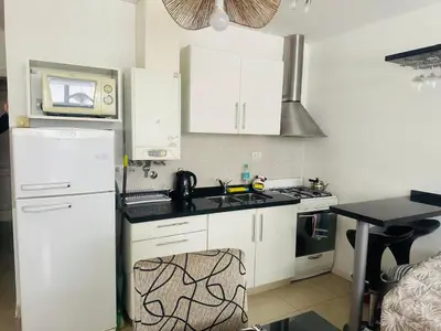 a kitchen with a white refrigerator and a microwave at Edificio Melos Villa Carlos Paz in Villa Carlos Paz