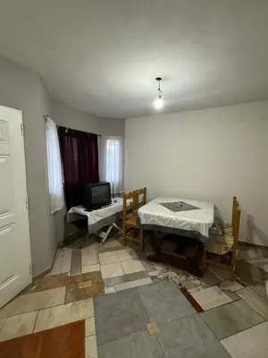 a room with a table and a television in it at Cabañas Antonia in San Javier