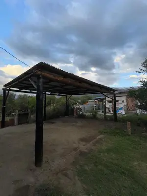 a wooden pavilion in the middle of a yard at Cabañas Antonia in San Javier