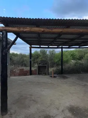 a large wooden structure with a fireplace in a field at Cabañas Antonia in San Javier