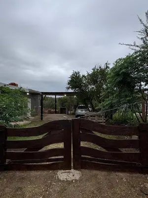 a wooden fence in front of a parking lot at Cabañas Antonia in San Javier