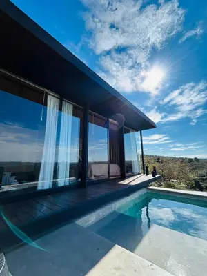 a villa with a swimming pool and a house at Suite del Alba in La Estancia