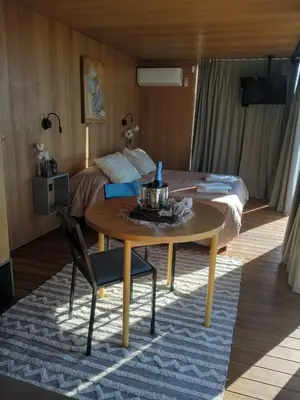a hotel room with a table and a bed at Suite del Alba in La Estancia