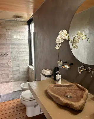 a bathroom with a sink and a toilet and a mirror at Suite del Alba in La Estancia