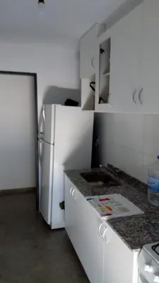 a kitchen with a refrigerator and a counter top at Departamento céntrico amplio in Río Cuarto