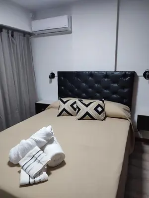 a bedroom with a bed with towels on it at Apartamento Los Capuchinos in Cordoba