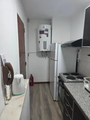 a kitchen with a stove and a refrigerator at Apartamento Los Capuchinos in Cordoba