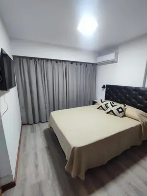 a bedroom with a large bed and a television at Apartamento Los Capuchinos in Cordoba