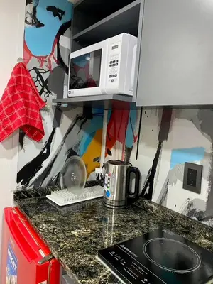 a kitchen with a counter top with a microwave at Estudio Lino in Cordoba