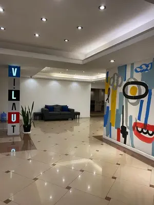 a lobby with a couch and a painting on the wall at Estudio Lino in Cordoba