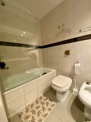 a bathroom with a toilet and a tub and a sink at Estudio Lino in Cordoba