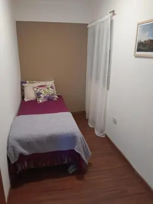 a small bedroom with a bed and a window at Hermoso Departamento en Güemes sobre Cañada in Cordoba