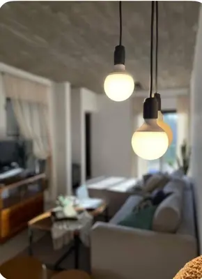 a living room with a couch and three lights at Casa de huésped in Río Tercero