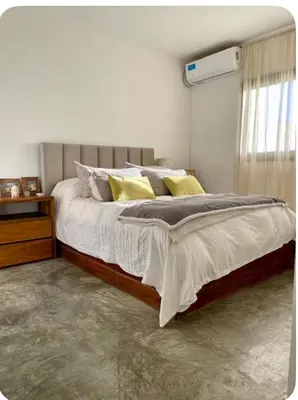 a bedroom with a large bed with yellow pillows at Casa de huésped in Río Tercero