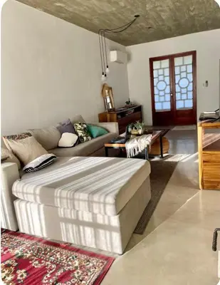 a living room with a bed and a couch at Casa de huésped in Río Tercero