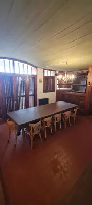 a large wooden table and chairs in a room at Casa Villa Carlos Paz in Villa Carlos Paz