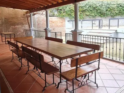 a wooden table and chairs on a patio at Casa Villa Carlos Paz in Villa Carlos Paz