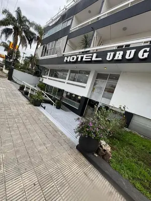 a hotel with a sign on the side of a building at Hotel Nuevo Uruguay in Villa Carlos Paz