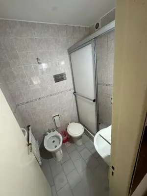 a small bathroom with a toilet and a sink at Hotel Nuevo Uruguay in Villa Carlos Paz
