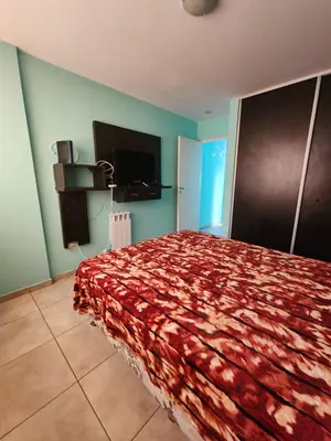 a bedroom with a bed and a flat screen tv at General Paz KT I 7 in Cordoba