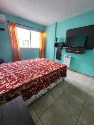 a bedroom with a bed and a television in it at General Paz KT I 7 in Cordoba